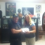 Uptown Cares. VET Inc getting check 10.10.11 VET Inc receiving donation from Uptown owner Beth Tedio
